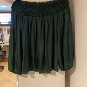 Off the shoulder blouse with long sleeves.